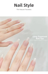 Detail of long coffin nail tips in pink white gradient on hand with a gold ring
