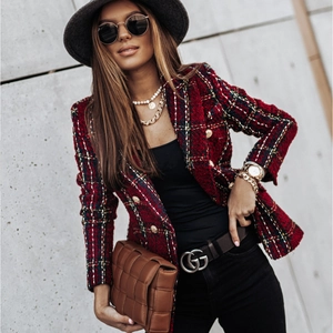 Outdoor shot of red plaid tweed blazer with gold buttons and a woven leather crossbody bag