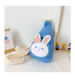 Close-up of light blue canvas chest bag featuring 3D white rabbit design and bow detail