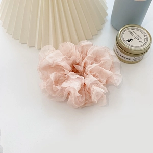 Detail shot of the pink organza hair scrunchie showing delicate lace and pleated texture