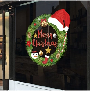 Christmas window wreath sticker featuring snowman, bells and candy canes on glass
