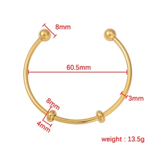 Minimalist gold stainless steel open cuff bracelet with round beads on white background