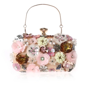 Detailed close-up of handmade 3D floral sequins and beadwork on champagne evening clutch