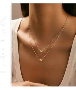 Detail of s925 silver double layer necklace with yellow and white marquise stones