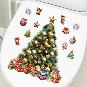Detailed Christmas tree and gift box stickers on a white toilet lid for holiday decor