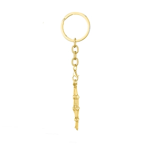 Detailed close-up of golden metal key chain featuring link chain and lobster clasp