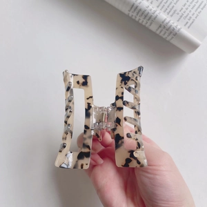 Close-up of tortoise shell pattern acetate hair claw clip with rectangle hollow design