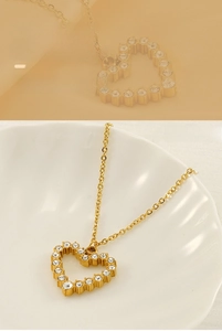 Detail of gold-plated stainless steel heart necklace with cubic zirconia pave stones