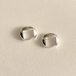 Close-up of minimalist S925 sterling silver hoop earrings with high polish finish