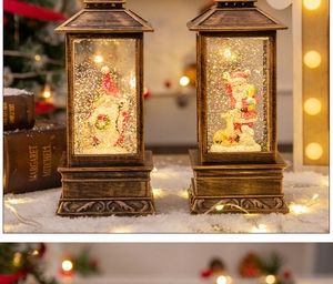 Detail of vintage bronze Christmas lantern with gnome and Santa scenes in snow globe