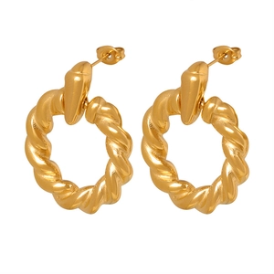 Minimalist gold plated twisted hoop earrings with a vintage metallic texture on white background