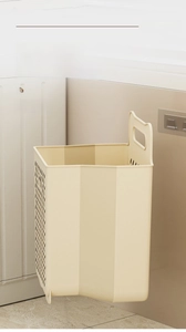 Detail showing cream-colored wall-mounted laundry basket with punch-free installation