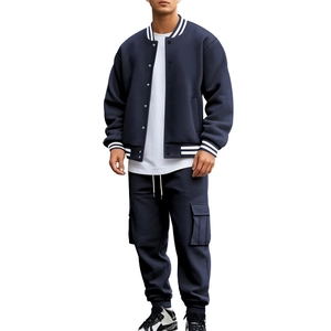 Detail of navy blue baseball jacket with white stripes on collar and matching cargo pants