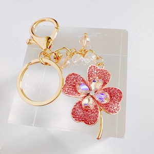 Sparkling pink rhinestone four-leaf clover keychain with gold metal chain and colorful beads