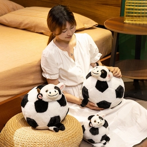 Three sizes of plush football cow toys with soft fabric in a warm home setting