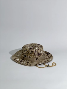 Close-up of desert digital camo boonie hat featuring metal eyelets and adjustable chin strap