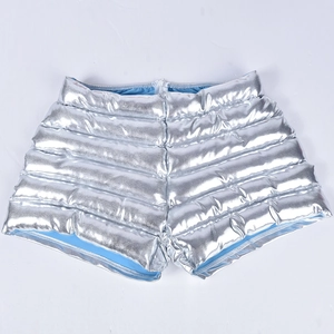 Detail of silver metallic quilted shorts with light blue lining and shiny waterproof coating