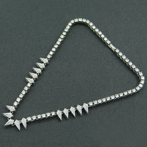 Detailed view of silver Cuban link necklace with V-shaped diamond spiked pendants