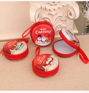 Detail of four festive red Christmas coin purses with zipper and holiday patterns