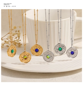Detail of sunburst pendants with faceted gemstones on gold and silver beaded chains