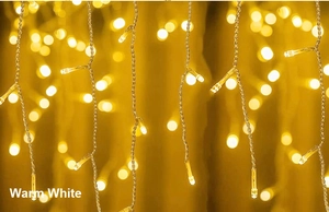 Detail of warm white LED icicle lights with elegant bokeh background and glowing effect
