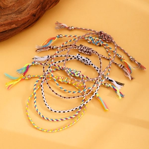 Close-up of colorful Bohemian woven friendship bracelets with tassels and beads