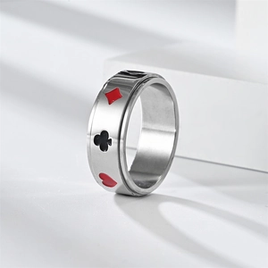 Macro detail of rotating silver steel ring with painted poker suit patterns