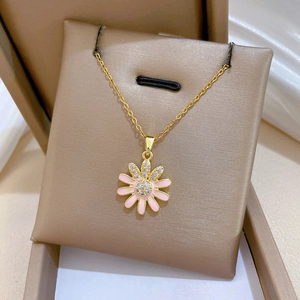 Titanium sunflower necklace with pink enamel petals and cubic zirconia in a jewelry box