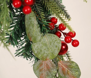 Detail of Christmas hanging decor with red berries, pine needles and eucalyptus leaves