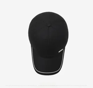 Top view of black baseball cap with white piping and a Fashion silver metal tag