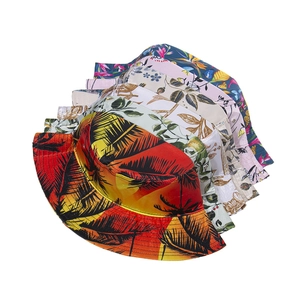 Detail showing various colorful floral and tropical palm leaf prints on silk bucket hats