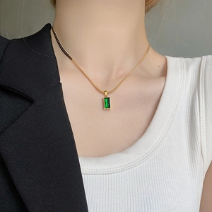 Luxurious gold stainless steel necklace featuring a rectangular green gemstone pendant