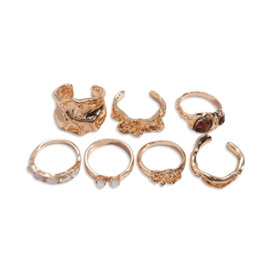 Set of 7 vintage gold metal rings featuring irregular wavy designs and resin stones