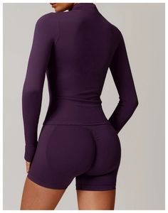 Rear view of purple seamless long-sleeve yoga top and high-waist lifting shorts