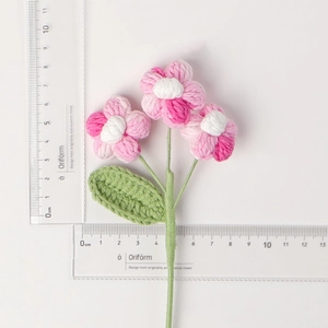 Detailed top view of handmade crochet flowers with size scale and pink white gradient petals