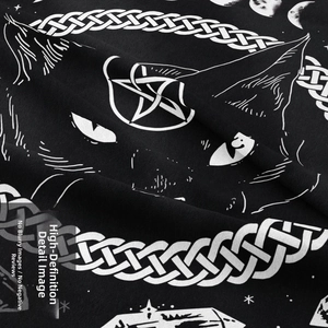 Macro detail of gothic black cat tapestry fabric showing intricate white occult screen printing