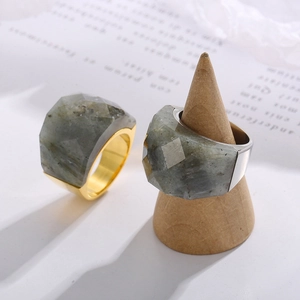 Faceted natural gray stone rings with 18K gold and silver plating on wood display