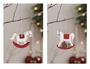 Detail of white and red wooden rocking horse ornaments hanging on a Christmas tree