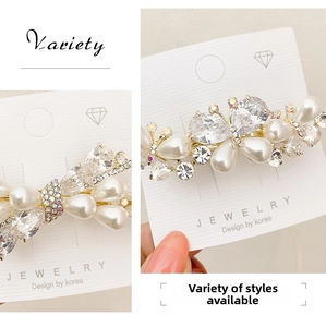 Detailed macro view of baroque butterfly hair clip with crystals and bright pearls