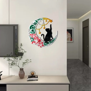 Detail view of crescent moon and black cat wall decor with floral accents and star pendant