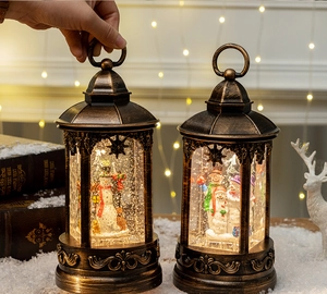 Detail of vintage bronze Christmas snow globe lantern with snowman and warm LED lights