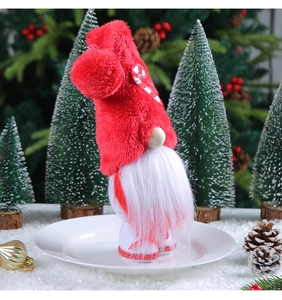 Close-up of plush Christmas gnome with red candy cane hat and white beard decoration