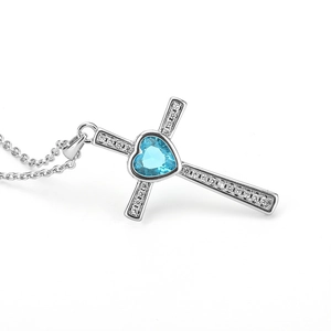 Silver cross heart necklace with aquamarine blue gemstone and tiny white zircons