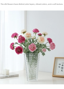 Detailed view of artificial peony silk flowers in a textured glass vase for home decor
