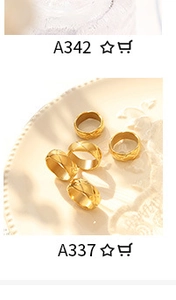 Detail view of gold textured rings with plain and diamond pattern on ceramic plate