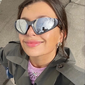 Detailed top view of Y2K silver sports sunglasses worn by a model in outdoor setting