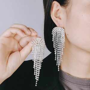 Detailed view of long silver fringe earrings with shimmering cubic zirconia tassels