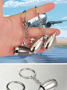 Detailed macro view of metal aircraft engine turbine fan keychains in silver and gunmetal