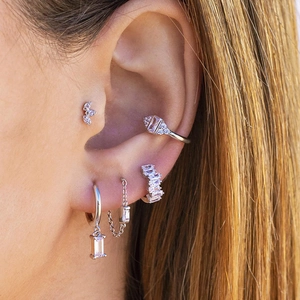 Elegant silver s925 earring set with white cubic zirconia worn as a stack