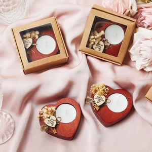 Close-up of heart-shaped wooden candle holder gift set with dried flowers and box